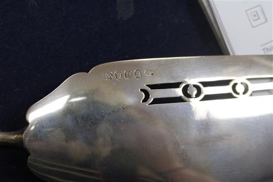 A George III silver fish slice with ivory handle, a later silver crumb scoop and pair of servers, all with ivory handles.
